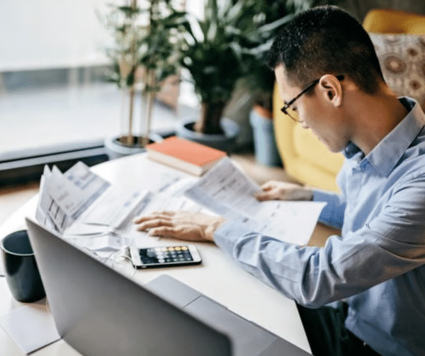 Homebuyer reviewing mortgage documents and financial paperwork during the underwriting stage of the home loan approval process.